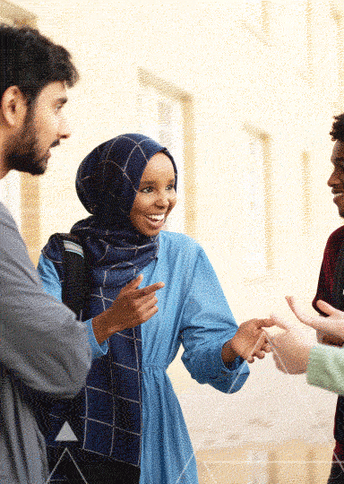 A group of people having a conversation in an outdoor