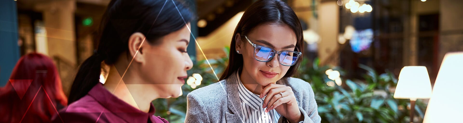 Two people are looking down while wearing professional clothes