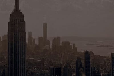 Buildings are shown in a ver dark weather