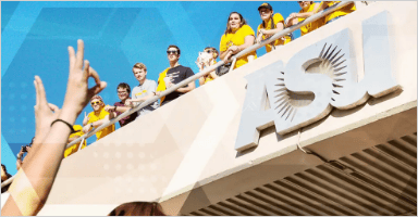 People on the bridge are wearing golden shirts while someone at the bottom is holding sun devils sign