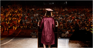 A graduate student is giving speech at the ceremony to the audience
